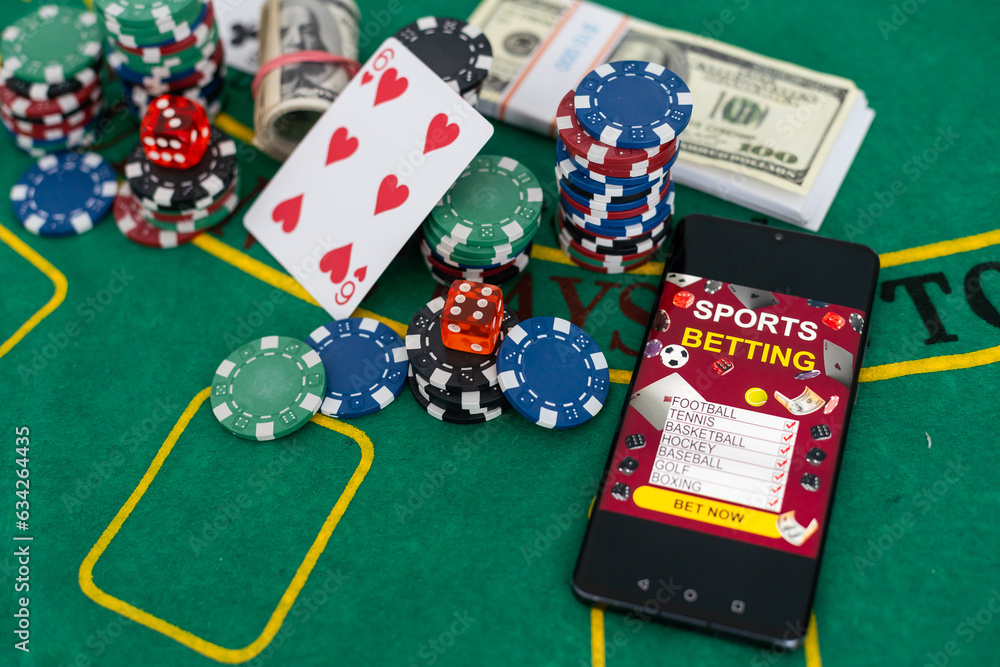 Fototapeta premium Poker chips with a bunch of dollars near a black tablet