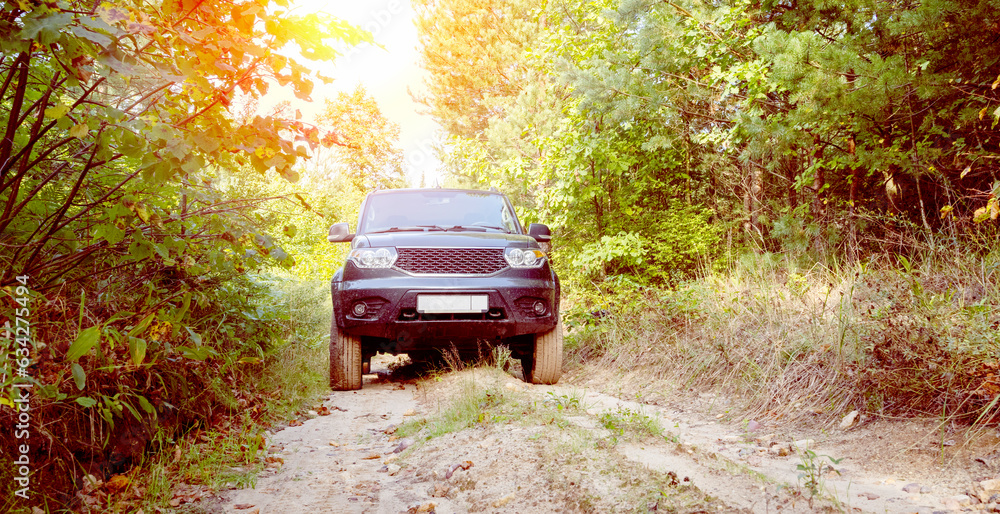 SUV on a forest road on a sunny day SUV on a forest road on a sunny day