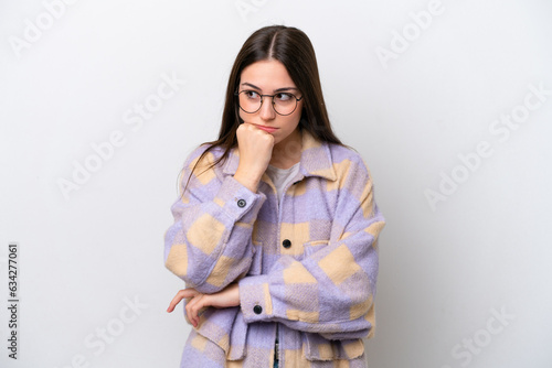 Young girl isolated on white background having doubts