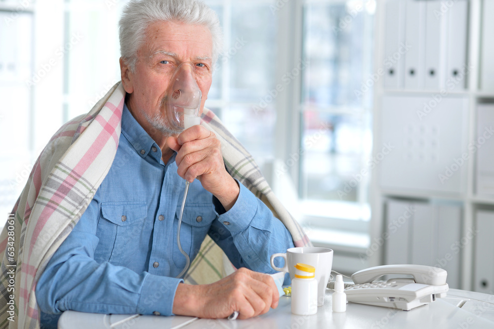 Sick elderly man makes inhalation Sick elderly man makes inhalation