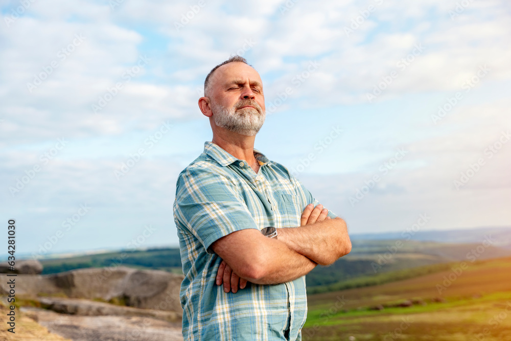 Bearded man traveler in a blue shirt taveling mountains in Peak District. Local tourism lifestyle concept. Bearded man traveler in a blue shirt taveling mountains in Peak District. Local tourism lifestyle concept.