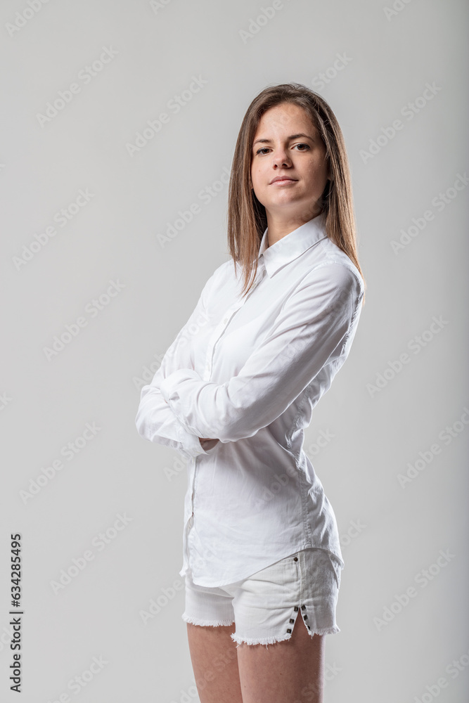 Fit woman in white, hip-hugging shirt, prefers tailored look Fit woman in white, hip-hugging shirt, prefers tailored look