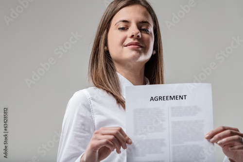 Woman with contract, white shirt, legal symbol photo