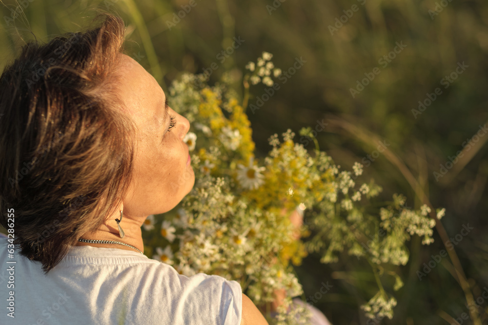 thoughtful, modern retiree immerses herself in tranquility of summer meadow, wildflowers in her hands serving as poignant reminder of life's continuous journey and her own resilience through life thoughtful, modern retiree immerses herself in tranquility of summer meadow, wildflowers in her hands serving as poignant reminder of life's continuous journey and her own resilience through life