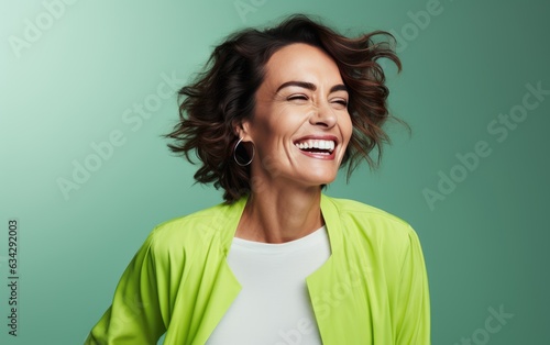 happy 40 years old ultra beauty Caucasian, who is smiling and laughing, wearing bright clothes. green background, studio photos. created by generative AI technology.