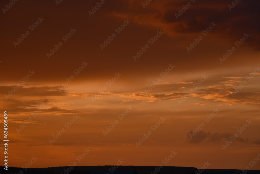 Pink clouds and evening sunset sky after a thunderstorm. Blue-red sunset evening. Beautiful pink clouds.