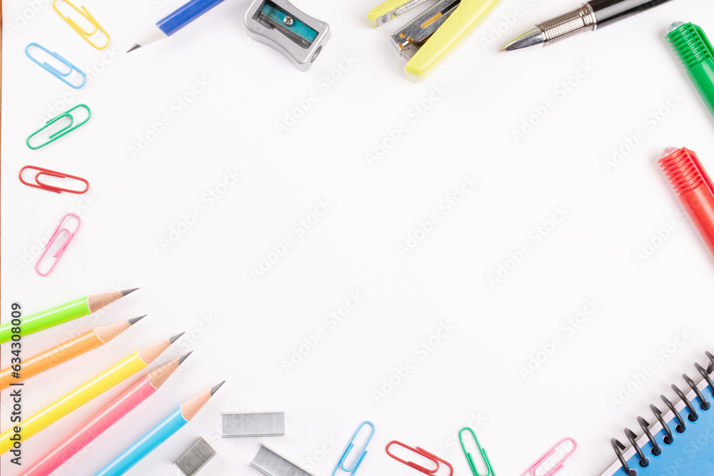 Top view of office supplies on white background with copy space for advertisement Top view of office supplies on white background with copy space for advertisement