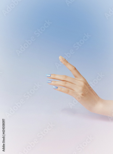 Closeup image of beautiful woman's hands with light pink manicure on the nails. Skin care for hands, manicure and beauty treatment. Elegant and graceful hands with slender graceful fingers