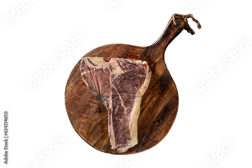 Siroy piece of beef meat T-bone, lies on a wooden board with spices. place for text, photon image. top view photo