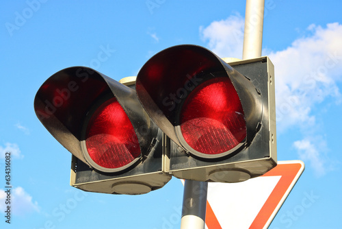 Traffic light with two red lights - the light signal of alternately flashing lights means that the driver is obliged to stop the vehicle photo