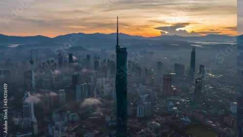 Aerial view hyperlapse 4k video of Kuala Lumpur city center view during dawn overlooking the city skyline in Federal Territory, Malaysia. Pan right photo