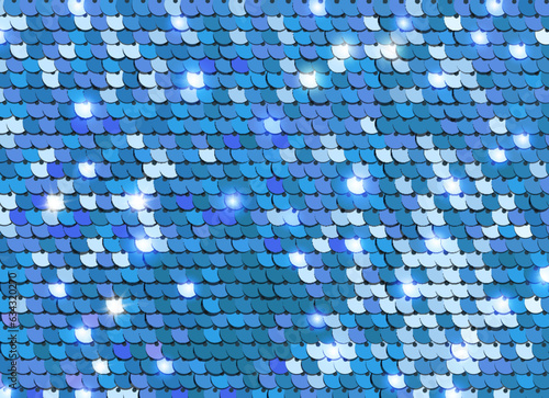 Shiny blue sequins or paillettes on fabric. Glittering sequined shining scales texture. Metallic background photo