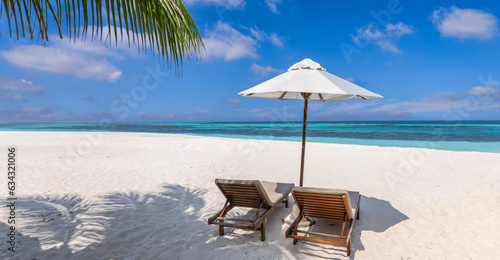 Fototapeta Naklejka Na Ścianę i Meble -  Amazing beach. Romantic chairs umbrella on sandy beach palm leaves, sun sea sky. Summer holiday, couples vacation. Love happy tropical landscape. Tranquil island coast relax beautiful landscape design