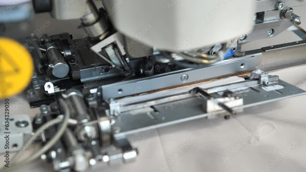 Close-up of the work of a specialized sewing machine for sewing pockets on clothes. Textile production, garment factory. Close-up of the work of a specialized sewing machine for sewing pockets on clothes. Textile production, garment factory.