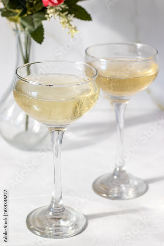 Champagne in glasses on a white background. Hard light