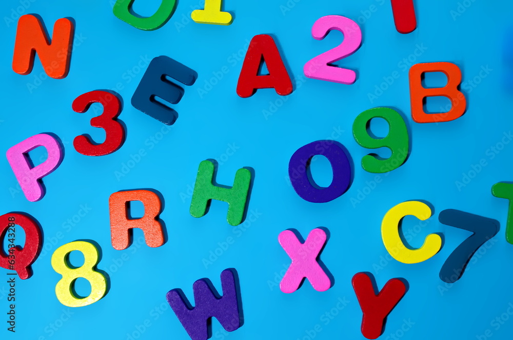Random colorful alphabet Wooden set letters numbers isolated on blue background Back to school concept Top view  Latin English alphabet Banner Poster preschool kindergarten Primary school poster child