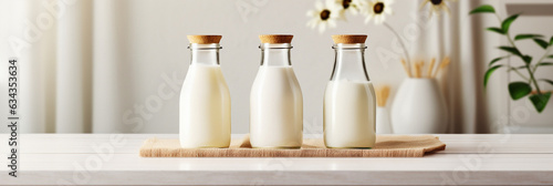 Milk bottles mockup on a table in the sunlight in the morning,healthy food,copy space,banner, dairy products for breakfast