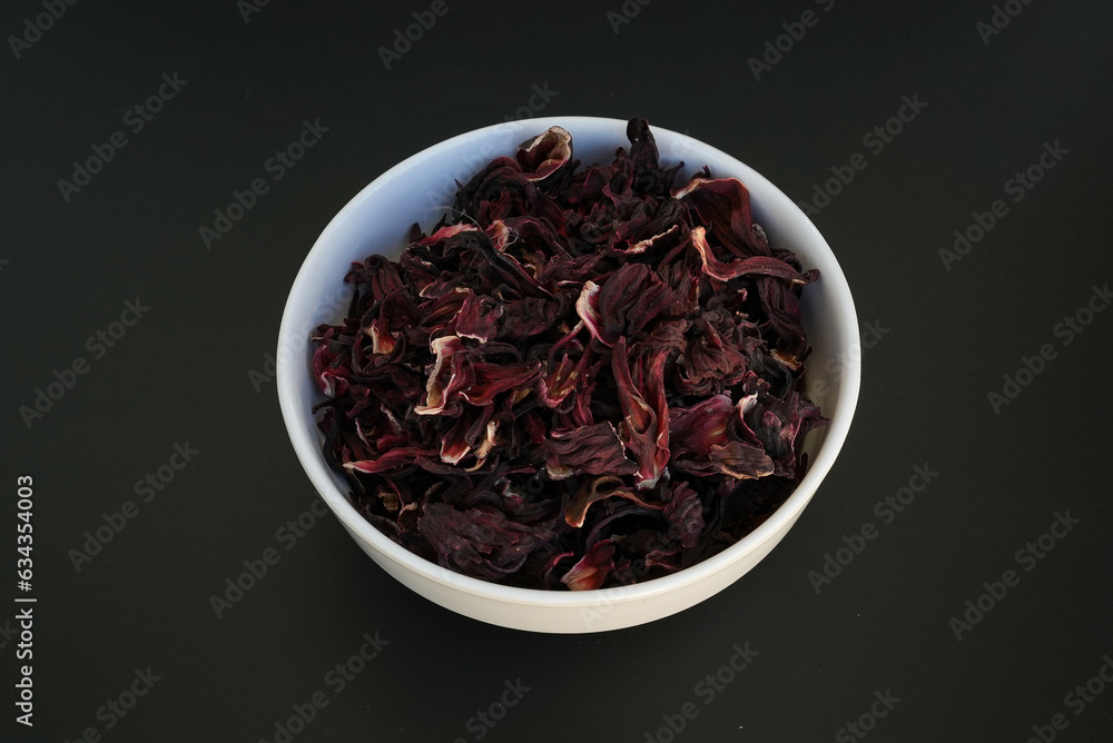 Dry roselle on a white plate on a black background Dry roselle on a white plate on a black background