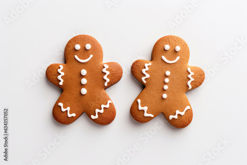 Festive, heartwarming composition of two homemade gingerbread man cookies with smiles. Cozy, hygge-inspired scene captures essence of holiday season, friendship, joy, perfect for Christmas, New Year. photo