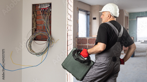 Electrician at work. Man fr...