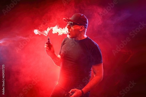 Man smokes vape. Guy with v...