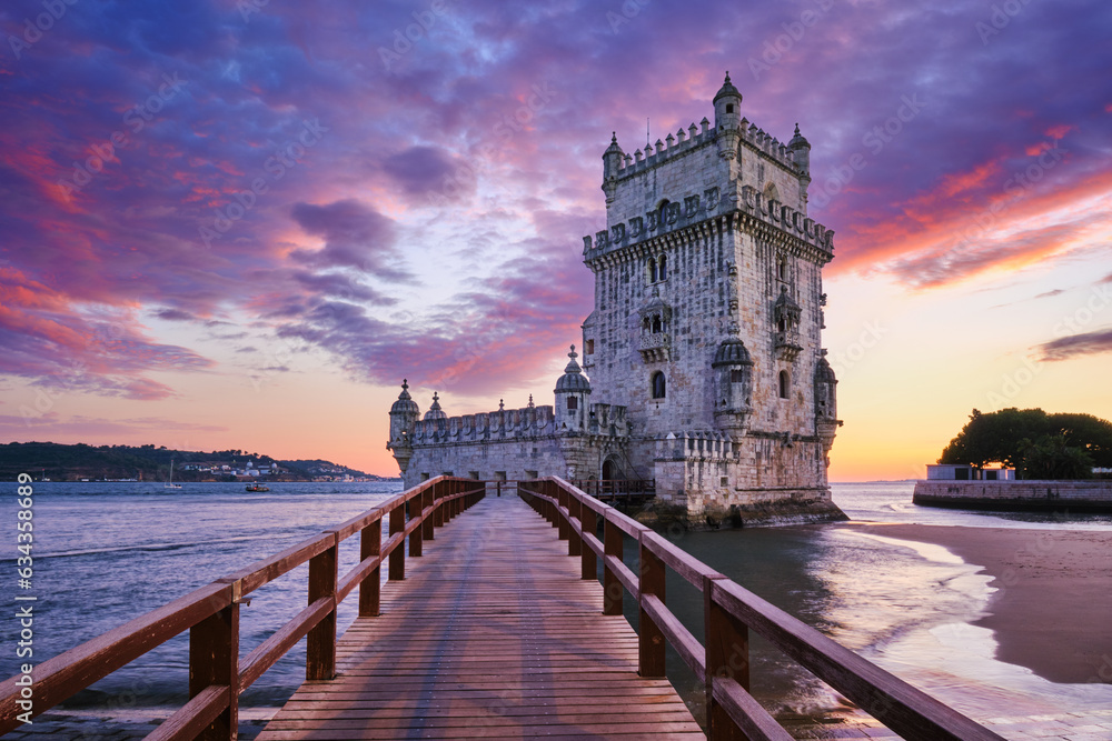 Belem Tower or Tower of St Vincent - famous tourist landmark of Lisboa and tourism attraction - on the bank of the Tagus River (Tejo) in evening dusk after sunset with dramatic sky. Lisbon, Portugal