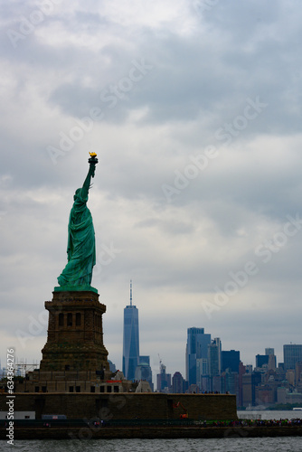 New York, New York, United States. August 07, 2023. Dramatic and detailed image of the Statue of Liberty with strong shades of green, sky with many clouds and very high resolution. © Paulo