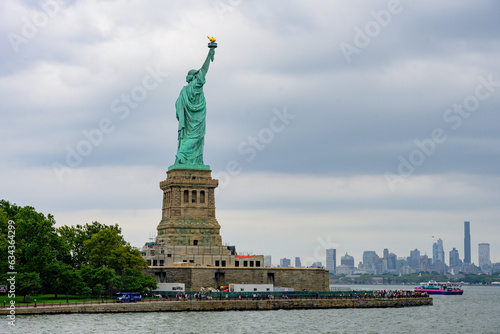 New York, New York, United States. August 07, 2023. Dramatic and detailed image of the Statue of Liberty with strong shades of green, sky with many clouds and very high resolution. © Paulo