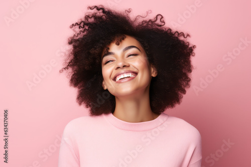 Radiant Smiles: Joyful African American Woman Poses in Vibrant Pink Studio