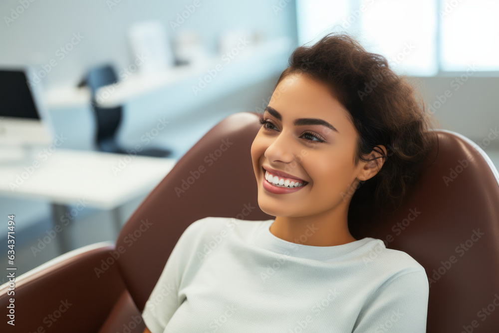 Fototapeta premium Smiling Mexican woman in dental chair