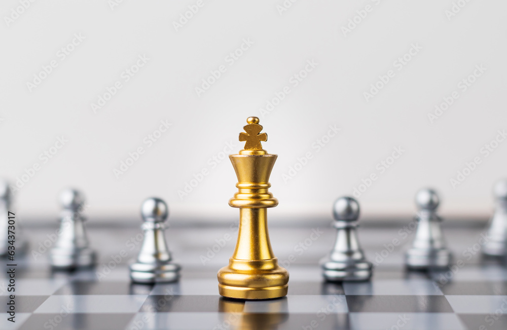 Leader, business strategy and planning concept, Gold Chess king figure on Chessboard and surrounded by a number of fallen silver chess pieces against opponent or enemy. Conflict, tactic, politic. Leader, business strategy and planning concept, Gold Chess king figure on Chessboard and surrounded by a number of fallen silver chess pieces against opponent or enemy. Conflict, tactic, politic.