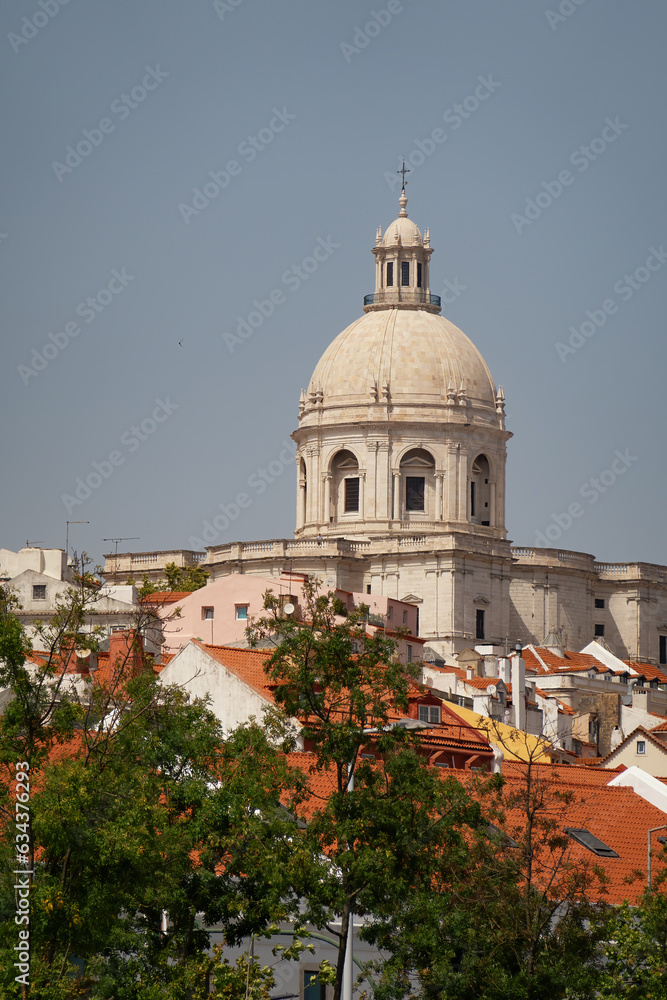 Beautiful view of rooftops in Lisbon, Portugal on a sunny day with space for text. National Pantheon set amongst the vibrant orange rooftops.