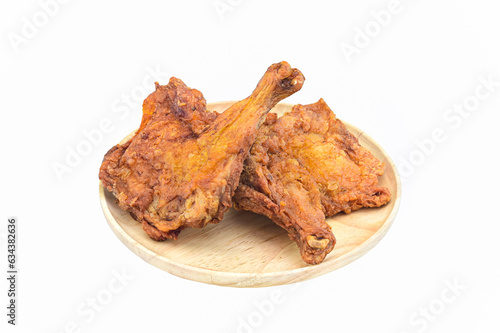 two fried chicken in wooden round tray on white background closeup,isolated