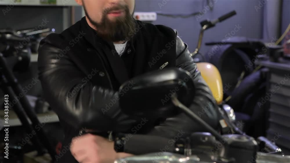 Male biker crosses his arms on his chest on the motorcycle Male biker crosses his arms on his chest on the motorcycle