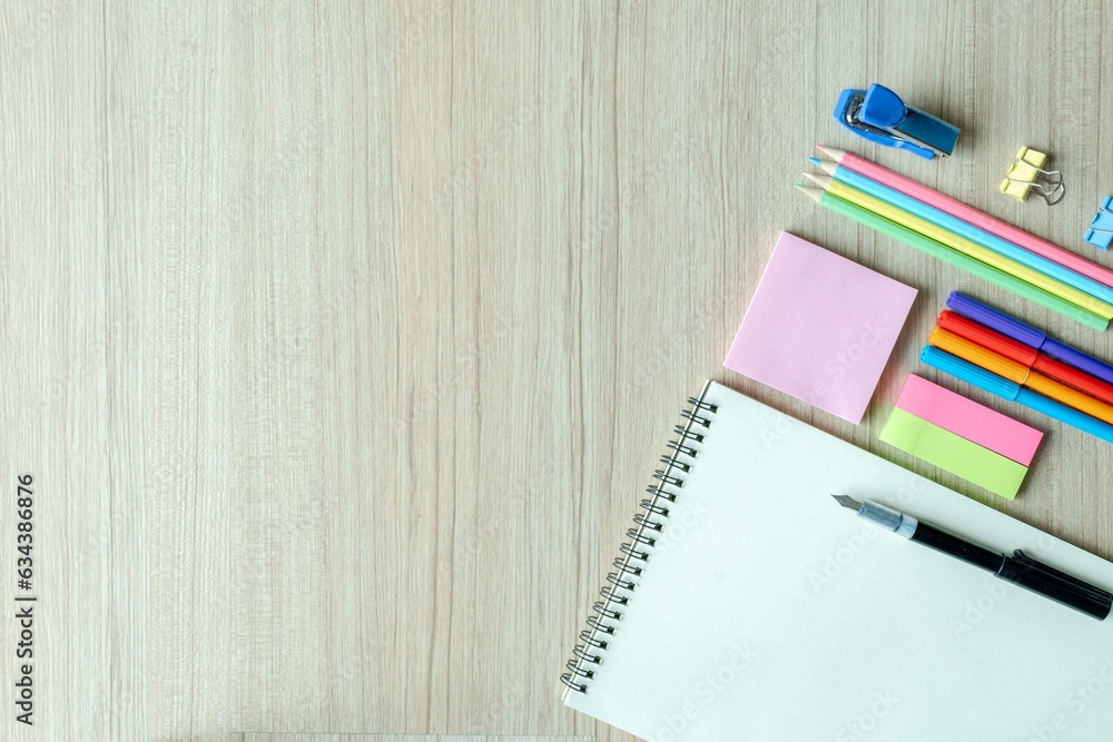 Top view photo, Back to school concept , Flat lay composition with school stationery, color pencils, paints, notepad on isolated wood background with copy space for text Top view photo, Back to school concept , Flat lay composition with school stationery, color pencils, paints, notepad on isolated wood background with copy space for text