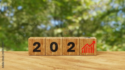 Business growth concept in 2024. Business goals and achievement. Sustainable development. Wooden cubes inscripted 2024 and growth icons. Positive indicators and trend concept. 4K 3D animation photo