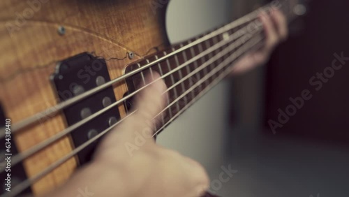 person slapping electric bass guitar photo