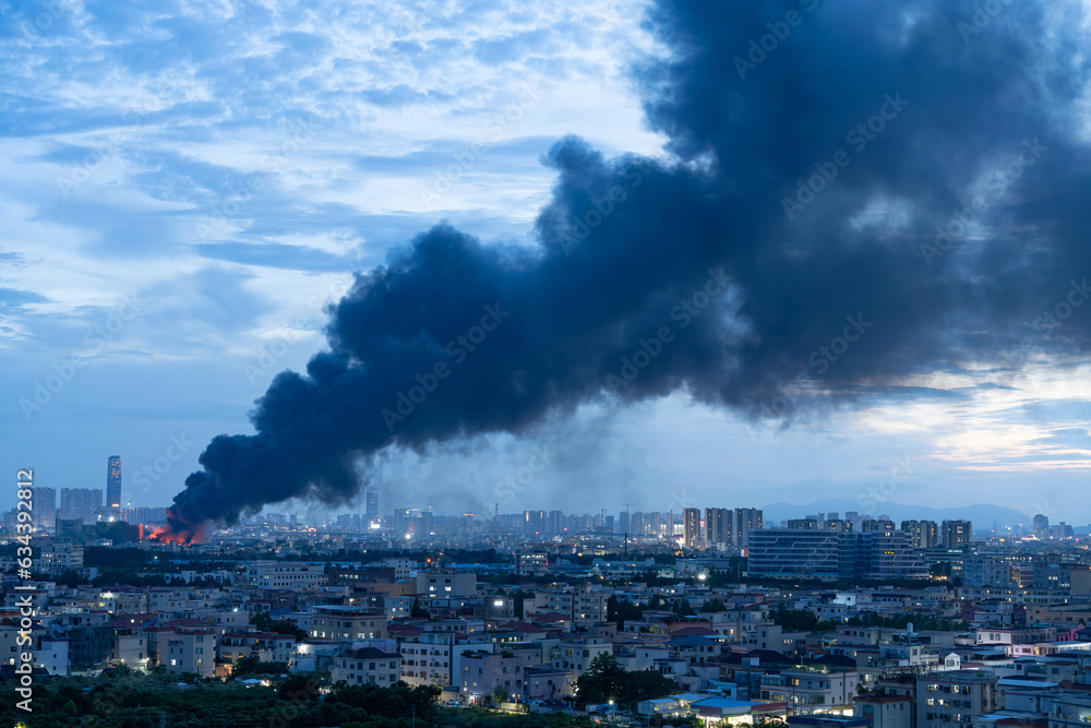 a factory catched a fire with lots dark smoke in sunset time horizontal composition a factory catched a fire with lots dark smoke in sunset time horizontal composition