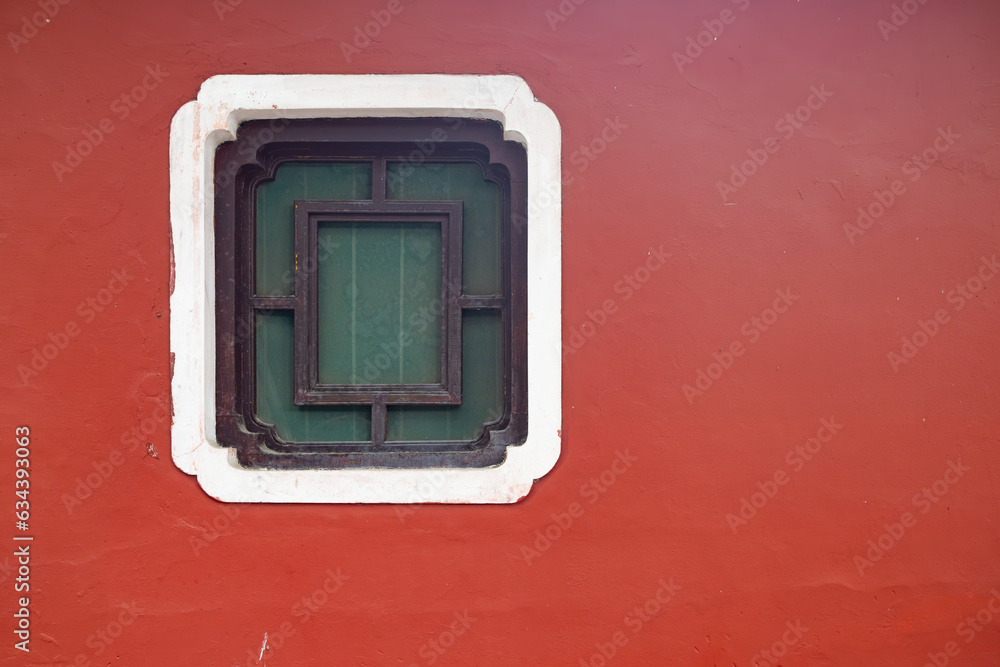 square shape window on a red wall