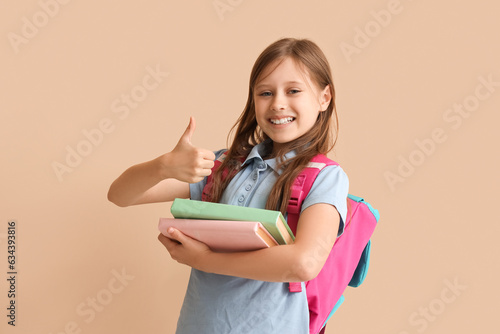 Little schoolgirl with book...