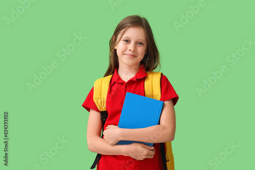 Little schoolgirl with book...