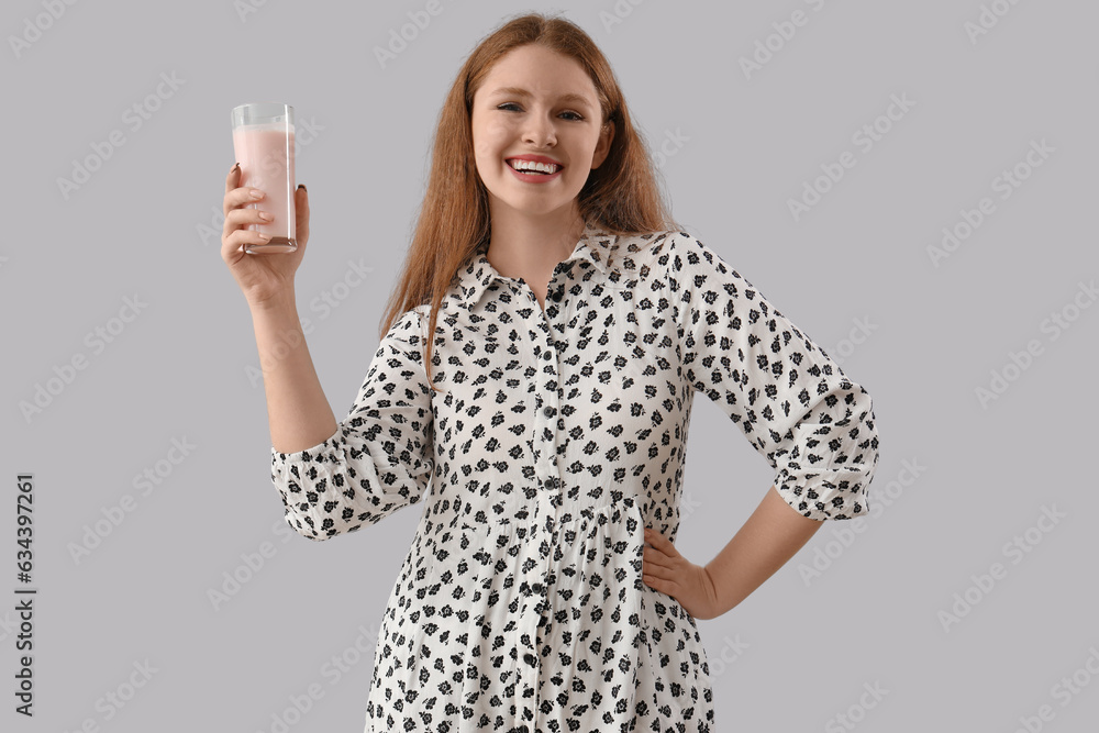 Young woman with tasty yoghurt on grey background Young woman with tasty yoghurt on grey background