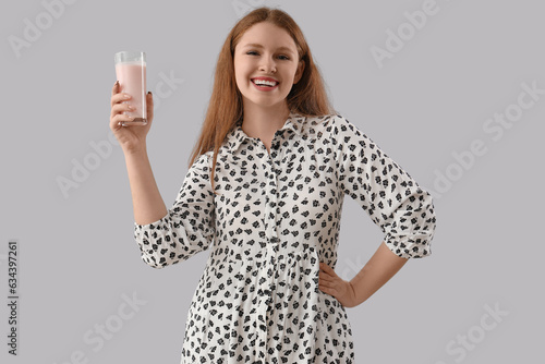 Smiling young woman holding...