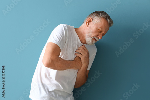 Mature man having heart att...