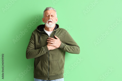 Mature man having heart att...