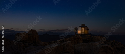banner or refuge by night on top of alps mountain Italy, sky with star, panorama, long exposure
