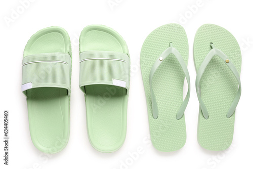 Colorful pairs of female flip flops on white background