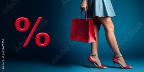 elegant slender legs of a young woman with a red handbag on a blue background. the concept of shopping and discounts