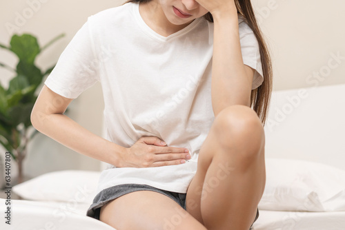 Flatulence ulcer, asian young woman, girl hands in belly, stomachache from food poisoning, abdominal pain and digestive problem, gastritis or diarrhoea. Abdomen inflammation, menstrual period people.
