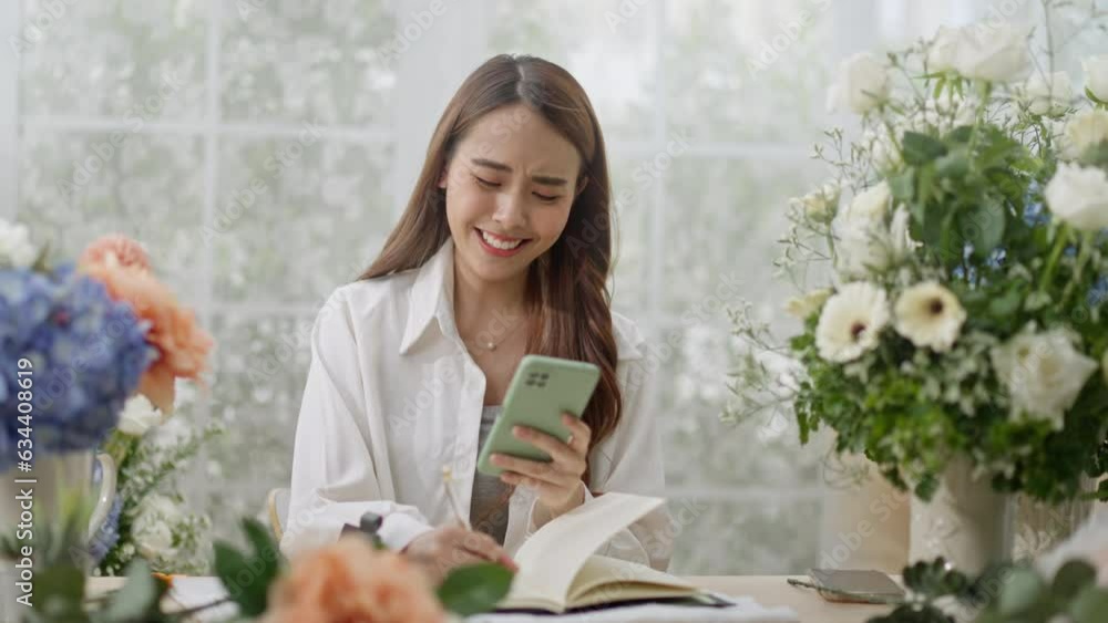 Small business,business online and New market concept.Young florist female use smartphone take photo bouquet of flower send to customer at workplace.woman artist working in flower shop studio at home Small business,business online and New market concept.Young florist female use smartphone take photo bouquet of flower send to customer at workplace.woman artist working in flower shop studio at home